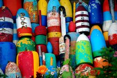 there are many different colored buoys on display