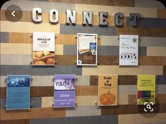 the wall is covered with posters and signs for different businesses, such as bread or croissants