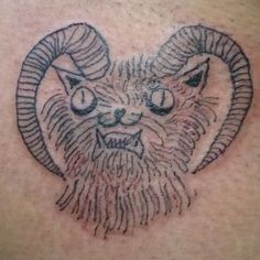 a ram tattoo on the back of a man's chest