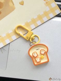 a keychain with an image of two bread slices on it and a pair of scissors