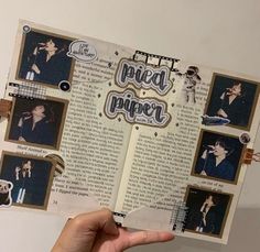 a person holding up a book with pictures on it and the pages are torn open