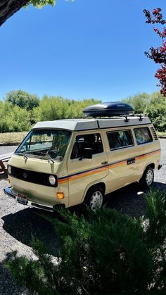 an old van parked in a parking lot with a surfboard on top of it