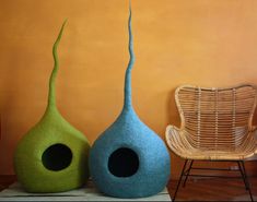 two blue and green vases sitting next to each other on top of a table