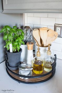 kitchen utensils and herbs are arranged on a tray