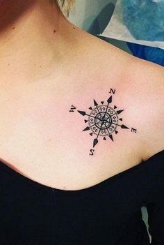 a woman with a black and white compass tattoo on her shoulder