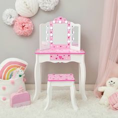 a white and pink vanity table with a mirror on it next to a teddy bear