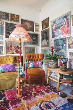 a living room filled with furniture and pictures on the wall