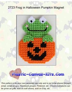 a crocheted pumpkin with a frog on it