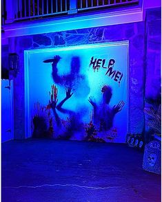 an open garage door with the words help me painted on it in purple and blue