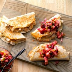 three quesadillas on a cutting board with fruit salsa