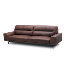 a brown leather couch sitting on top of a white floor