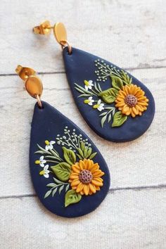 two sunflowers and daisies painted on blue leather tear earrings