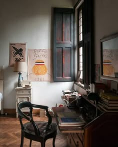 a bedroom with a bed, desk and chair next to an open window on the wall