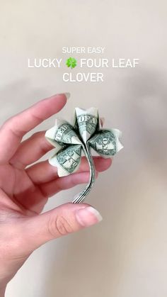 a person holding money in their hand with the text super easy lucky four leaf clover