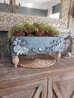 an old dresser with some plants in it and other decorations on top of the drawers