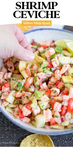 shrimp ceviche in a bowl with tortilla chips and lime wedges