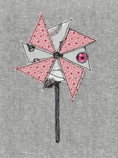 an image of a pink and white pinwheel on grey fabric with polka dot print