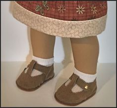 the legs of a child wearing brown shoes