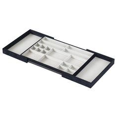 a black and white tray with several compartments for small objects in it, on a white background