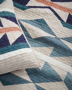 an image of a quilt that has been made with blue and orange colors on it