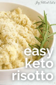 a white bowl filled with mashed potatoes and herbs