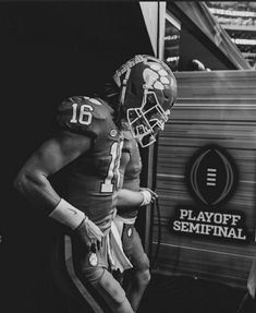 two football players in uniforms standing next to each other