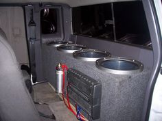 the interior of a vehicle with three subs in it