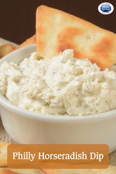 a bowl of dip with crackers on the side and text overlay that reads phily horseradish dip