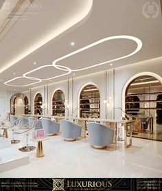 the interior of a luxury salon with white walls and marble flooring, large circular chandeliers