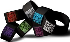 several different colored bracelets with qr code designs on them, all stacked together