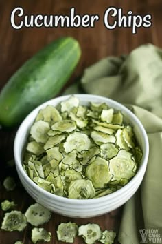 a white bowl filled with cucumber chips on top of a wooden table