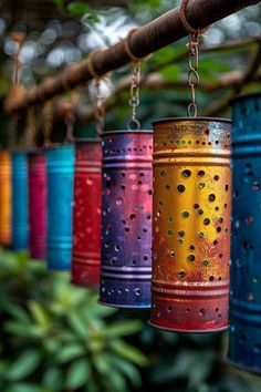 colorful metal canisters hanging from a tree branch