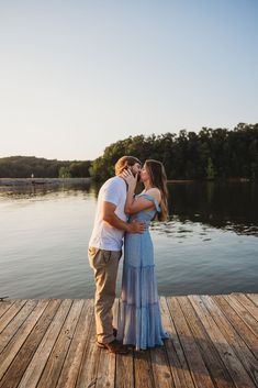 a man and woman kissing on a dock with the caption fall engagement inspiration for southern brides