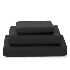 black sheets and pillow cases on a white background