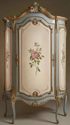 an ornate blue and gold painted cabinet with roses on it