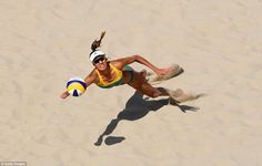 a woman is playing volleyball in the sand