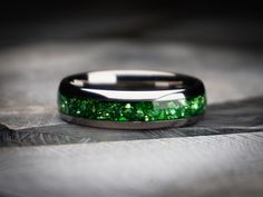 a wedding band with green glitter inlays