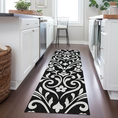 a black and white runner rug in a kitchen