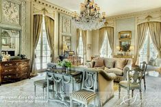 an elegant living room with chandelier and furniture