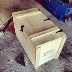 a wooden box sitting on top of a floor