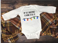 Christmas Onesie; Lit First Christmas Onesie; Christmas Baby Outfit; Newborn Christmas Onesie; My First Christmas Baby Outfit by CuttingUpAStorm Newborn Christmas Onesie, First Christmas Onesie, Onesie Designs, My 1st Christmas, Boy Baptism Outfit, First Christmas Baby, Christmas Onesie, Baptism Outfit