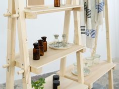 a wooden shelf with bottles and candles on it