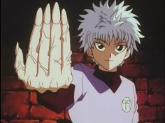 an anime character with white hair holding his hand up in front of the camera while standing next to a brick wall