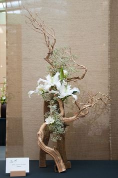 a vase filled with white flowers sitting on top of a table