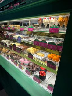 a display case in a bakery filled with lots of different types of cakes and pastries