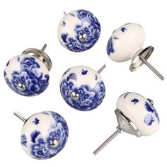 six blue and white knobs with flowers on them