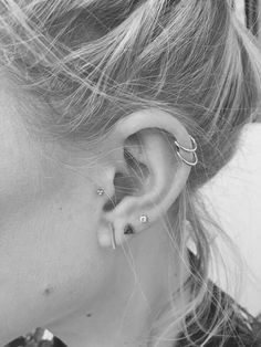 black and white photograph of woman with ear piercings