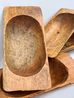 three wooden bowls sitting on top of each other