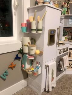 a toy kitchen is shown with toys on the shelves