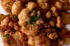 some food that is on top of a white paper towel with parsley and seasoning